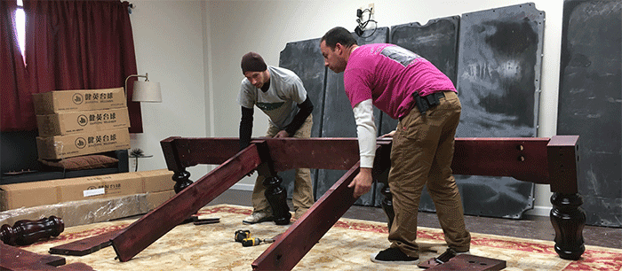 Our pool table movers breaking down a table and preparing it for transport.