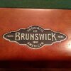 Brunswick Billiards metal logo stamp on the rail