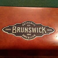 Brunswick Billiards metal logo stamp on the rail