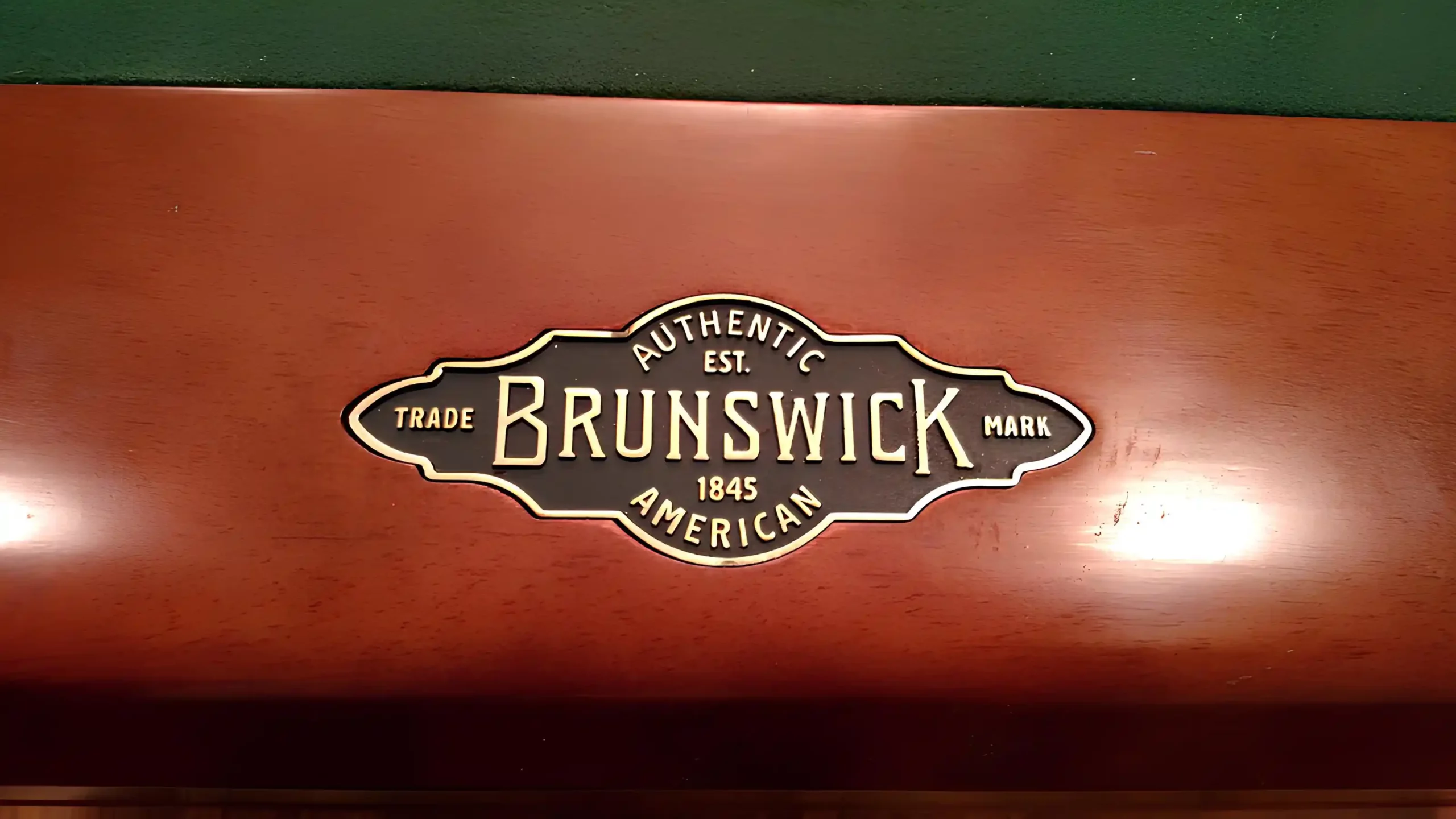 Brunswick Billiards metal logo stamp on the rail