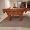End view of a used Brunswick Cottage Grove pool table