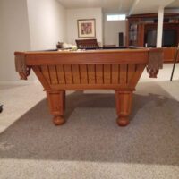 End view of a used Brunswick Cottage Grove pool table