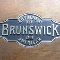 Authentic Brunswick logo embossed on Gibson pool table rail.