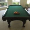 Used Olhausen Santa Ana pool table with pool balls on it
