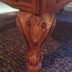 Intricately carved legs of the Olhausen Montrachet pool table.