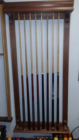 Brunswick solid cherry pool cue rack for the wall.