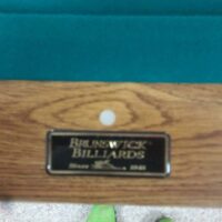 Metal Brunswick logo embossed on rail