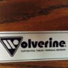 Wolverine logo embossed on rail of Saturn pool table.