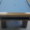 End view of a Brunswick Bridgeport pool table in a honey finish.