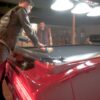 racking a set of balls on a 1969 Chevy Camaro Z28 car pool table with black cloth.