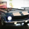 1969 collectors Chevy Camaro car pool table in blue with white racing stripes.