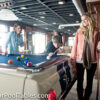 player takes a shot on a blue clothed 1965 Ford Mustang GT-350 pool table.