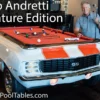 Mario Andretti standing next to the Car Pool Table replica of his 1969 Chevy Camaro pace car!