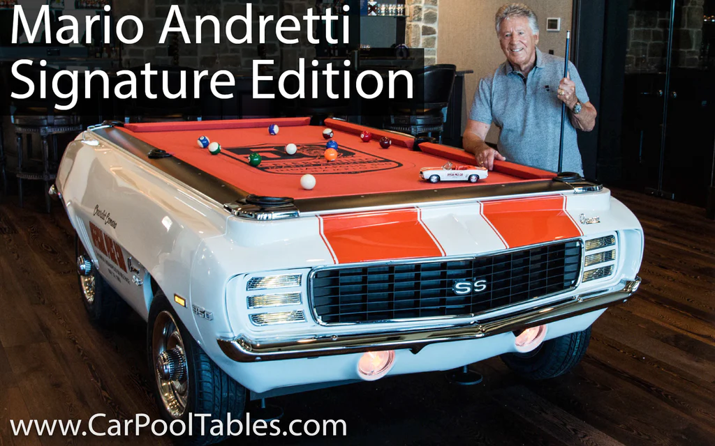 Mario Andretti standing next to the Car Pool Table replica of his 1969 Chevy Camaro pace car!