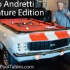 1969 Mario Andretti Signature Camaro pool table from Car Pool Tables with Mario standing next to the table holding a pool cue.